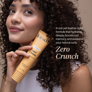 Model with defined curls holding KITSCH Moisturizing Curl Cream: A rich yet feather-light formula that hydrates deeply, boosts curl memory, and awakens your natural curls. Zero Crunch