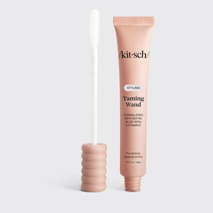 KITSCH Styling Taming Wand — hero shot of the pink tube beside its silicone spoolie applicator on a light gray background — lightweight, clear formula smoothes strands without stickiness or white residue — glide spoolie over flyaways, frizz, and edges for a smooth, polished finish