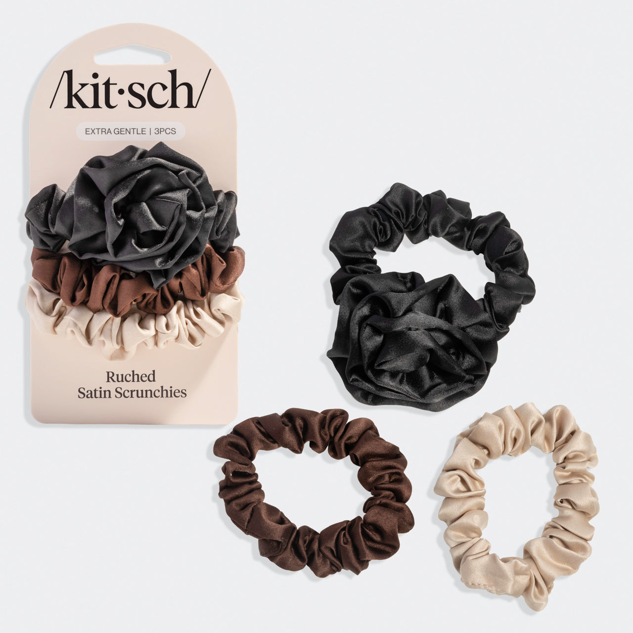 Set of black rosette ruched satin scrunchies with packaging labeled 'kitsch'.