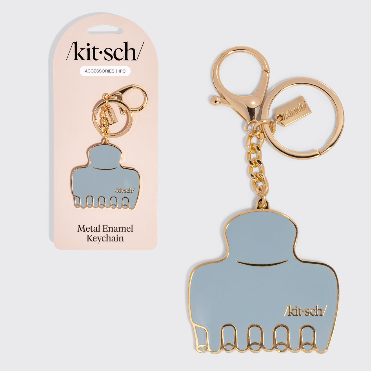 Metal enamel keychain of the kitsch Haze Blue Cloud Clip with packaging on a light gray background