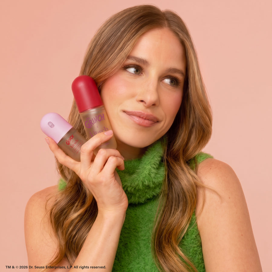 Model holding The Grinch x Kitsch Cindy-Lou Duo Set Cherry Cheer and Whoville Cookies Hair Perfumes