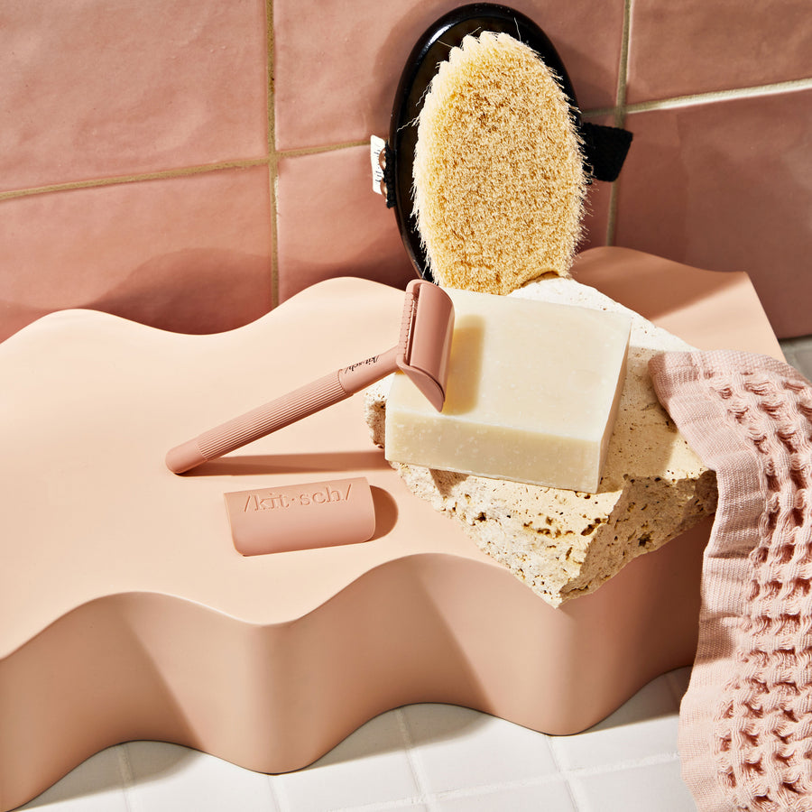 KITSCH Solid Shave Butter — model applying shave butter to leg — Hydrating, buttery formula works to cushion your shave while nourishing your skin — reduces single-use plastic: saves two bottles of shaving cream